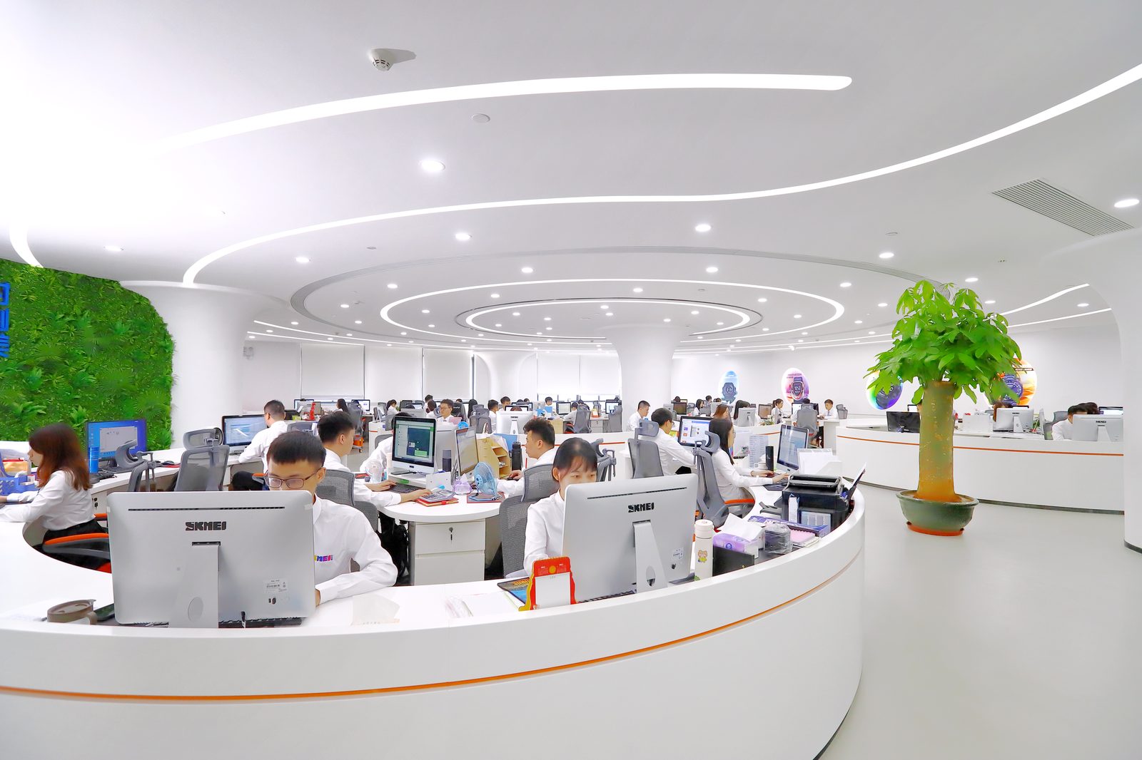 Open-plan office with SKMEI sales and service staff at workstations