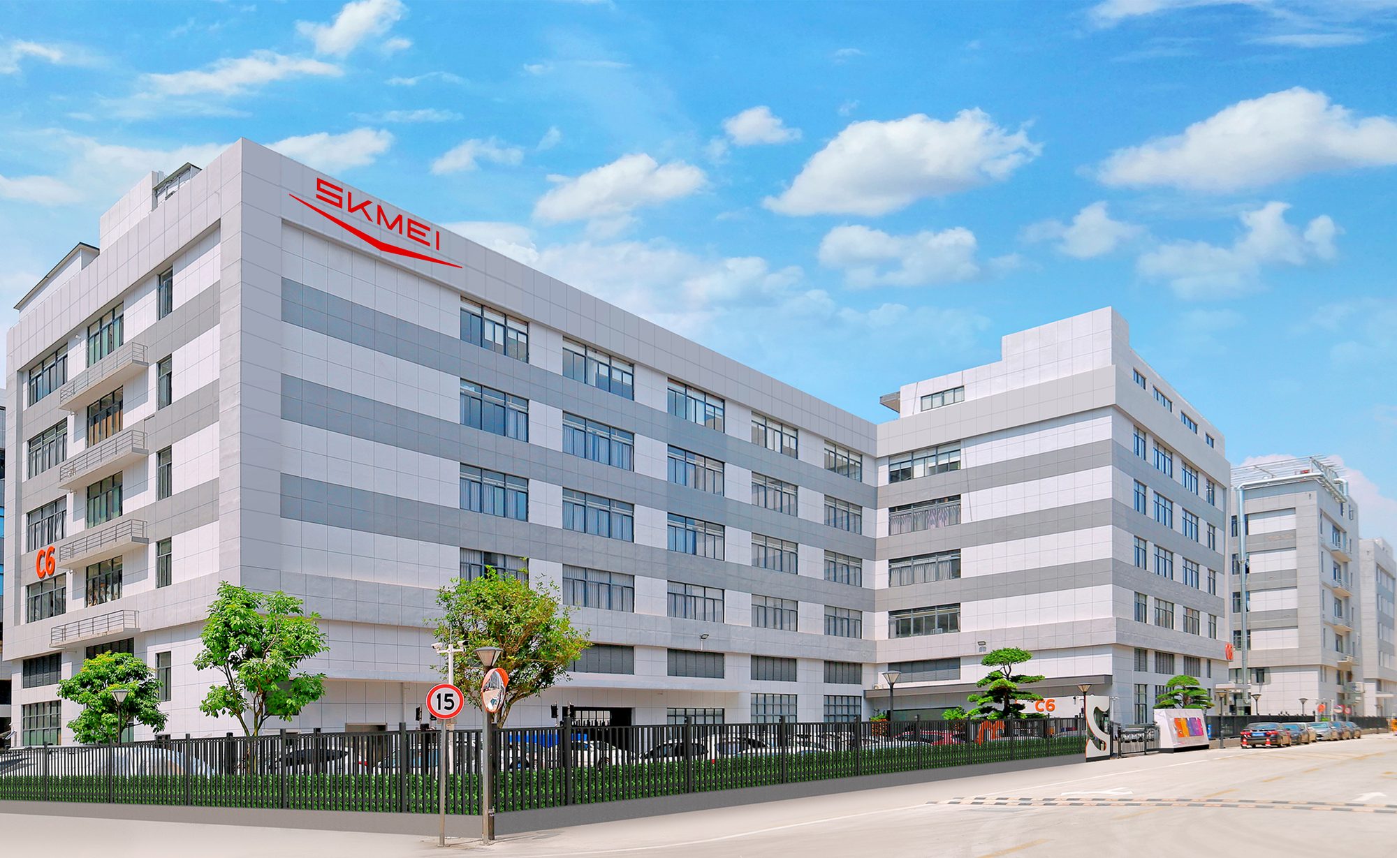 SKMEI C6 manufacturing plant exterior with red brand signage under a blue sky
